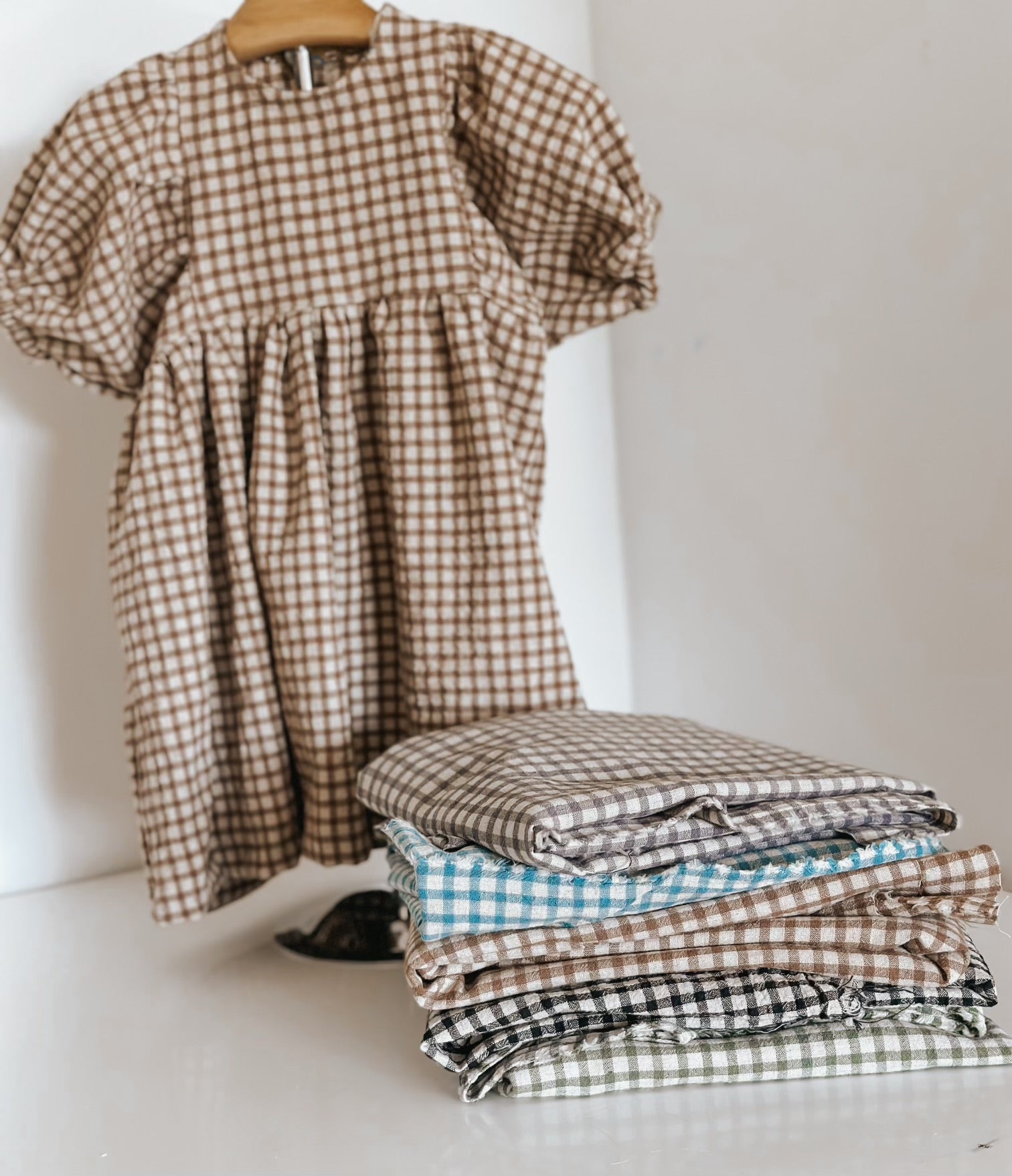 Gingham dress and fabric swatches in various colors.
