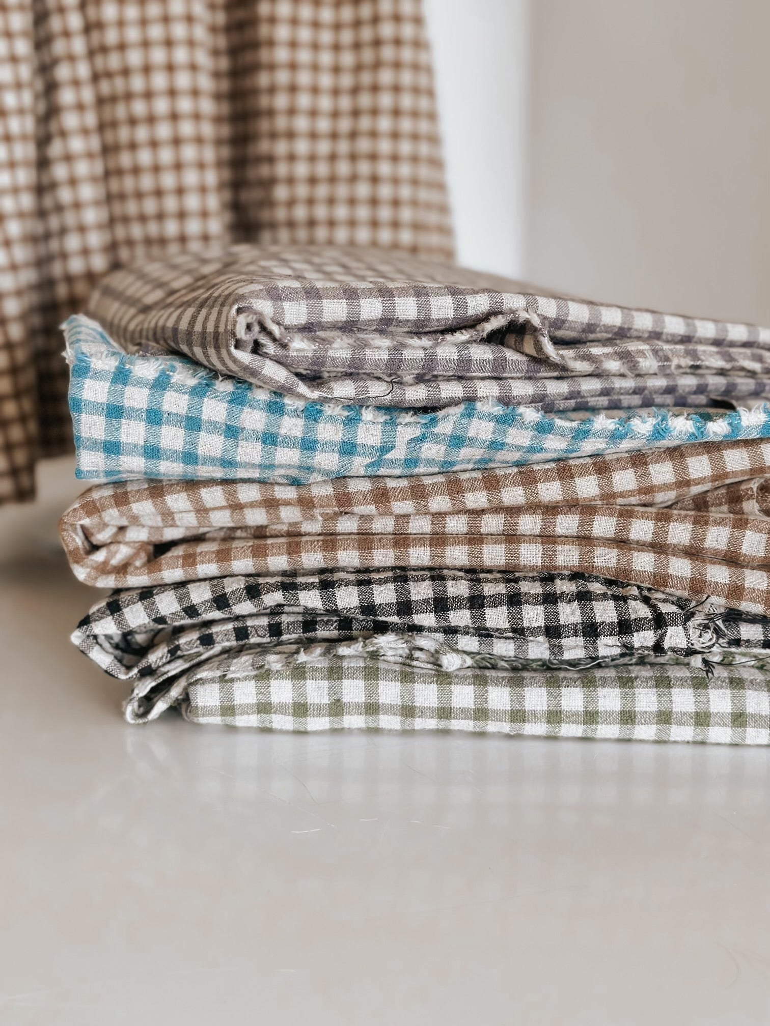 Stack of checkered fabric in various colors