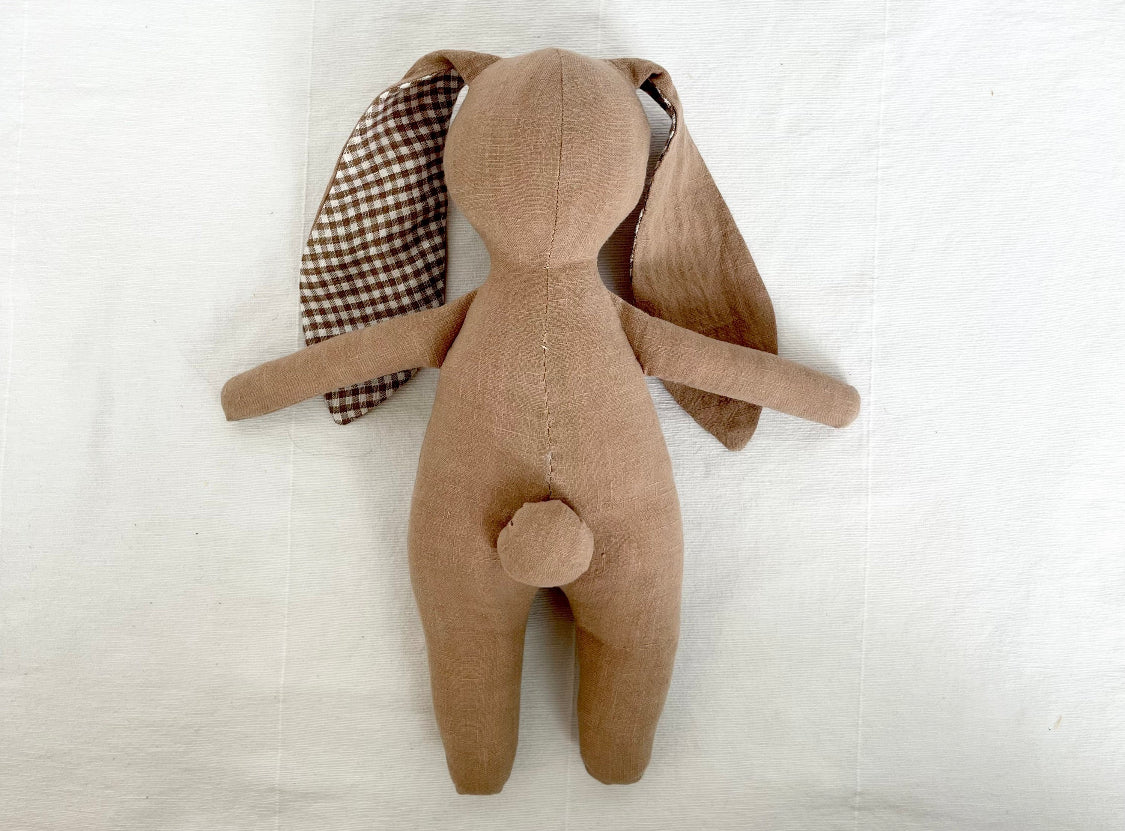 Brown bunny plush toy with checked ear detail