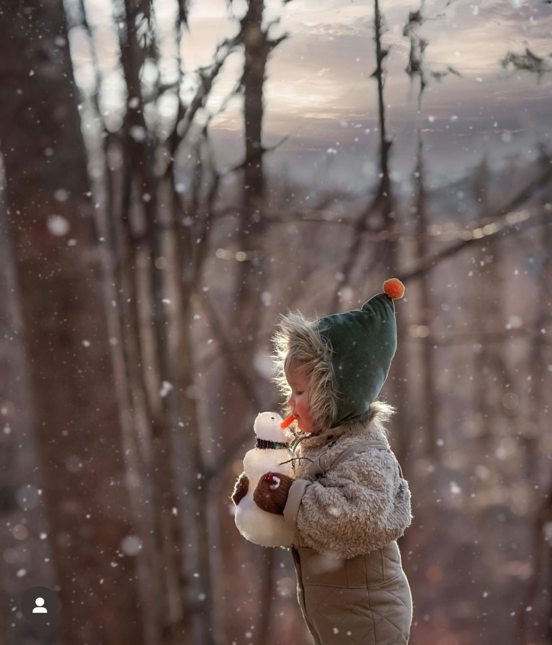 Child in winter holding snowman