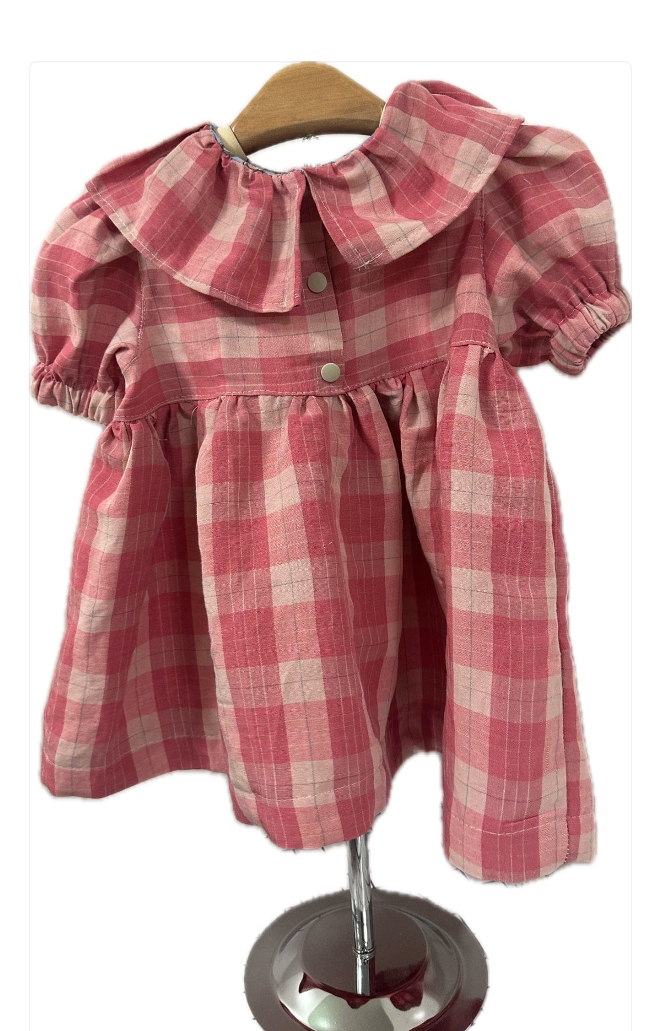 Pink plaid dress on hanger