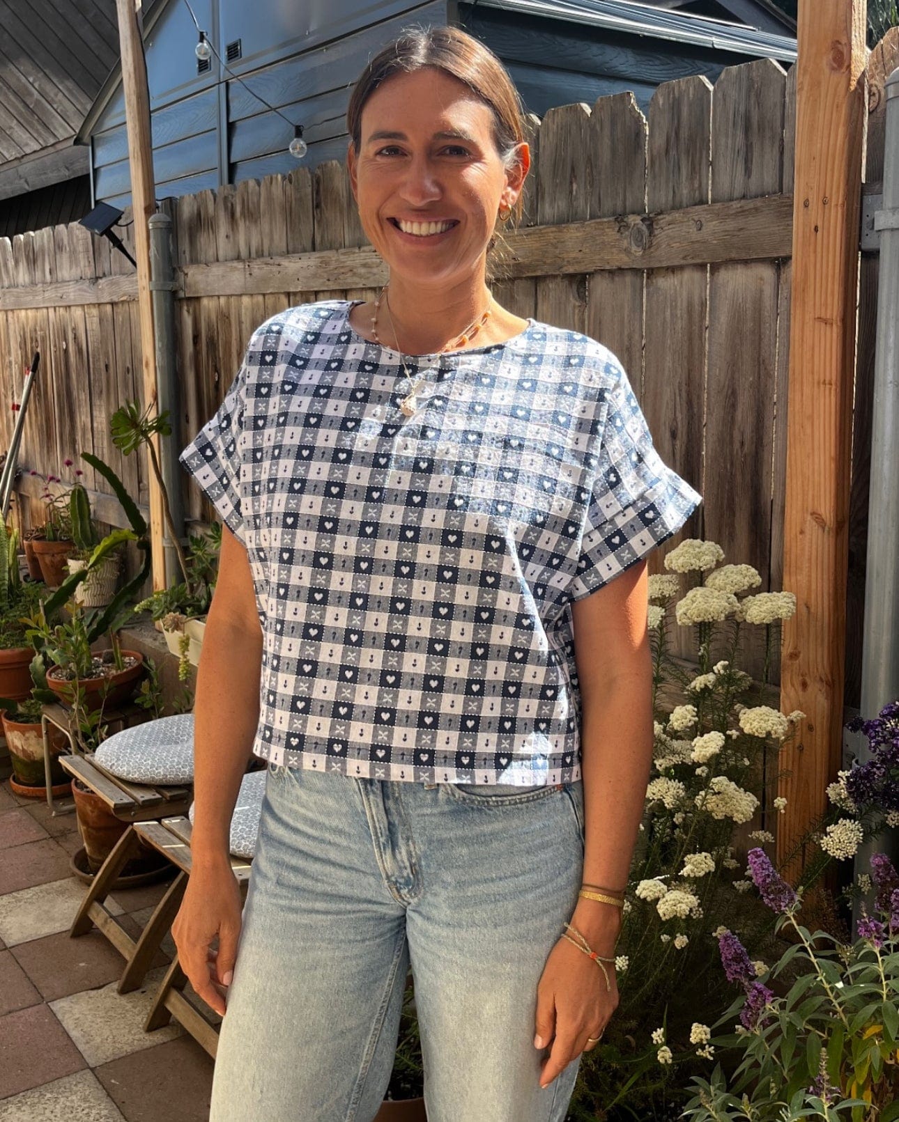 Woman in blue checkered top and jeans