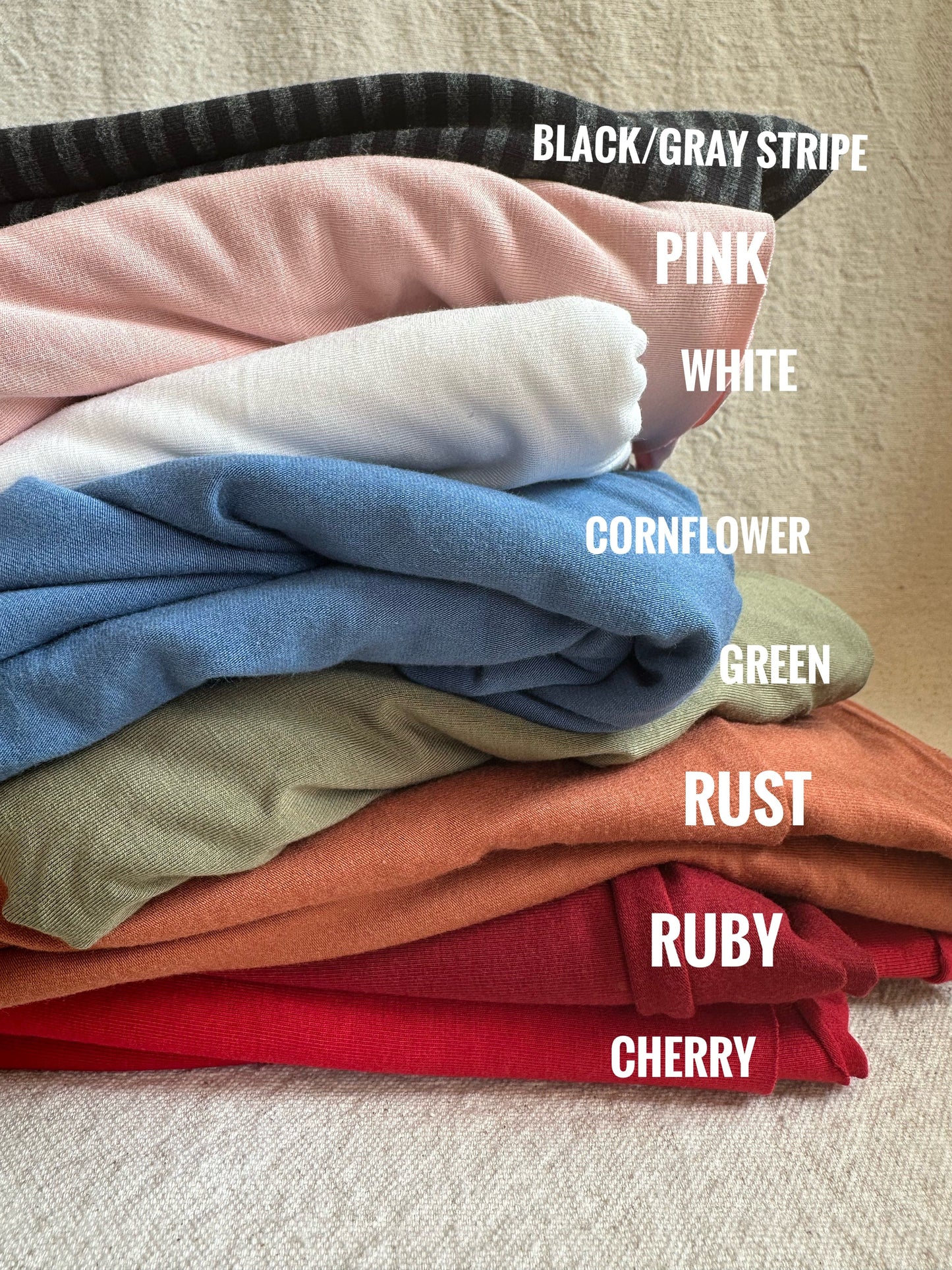 Pile of colorful fabric in various shades