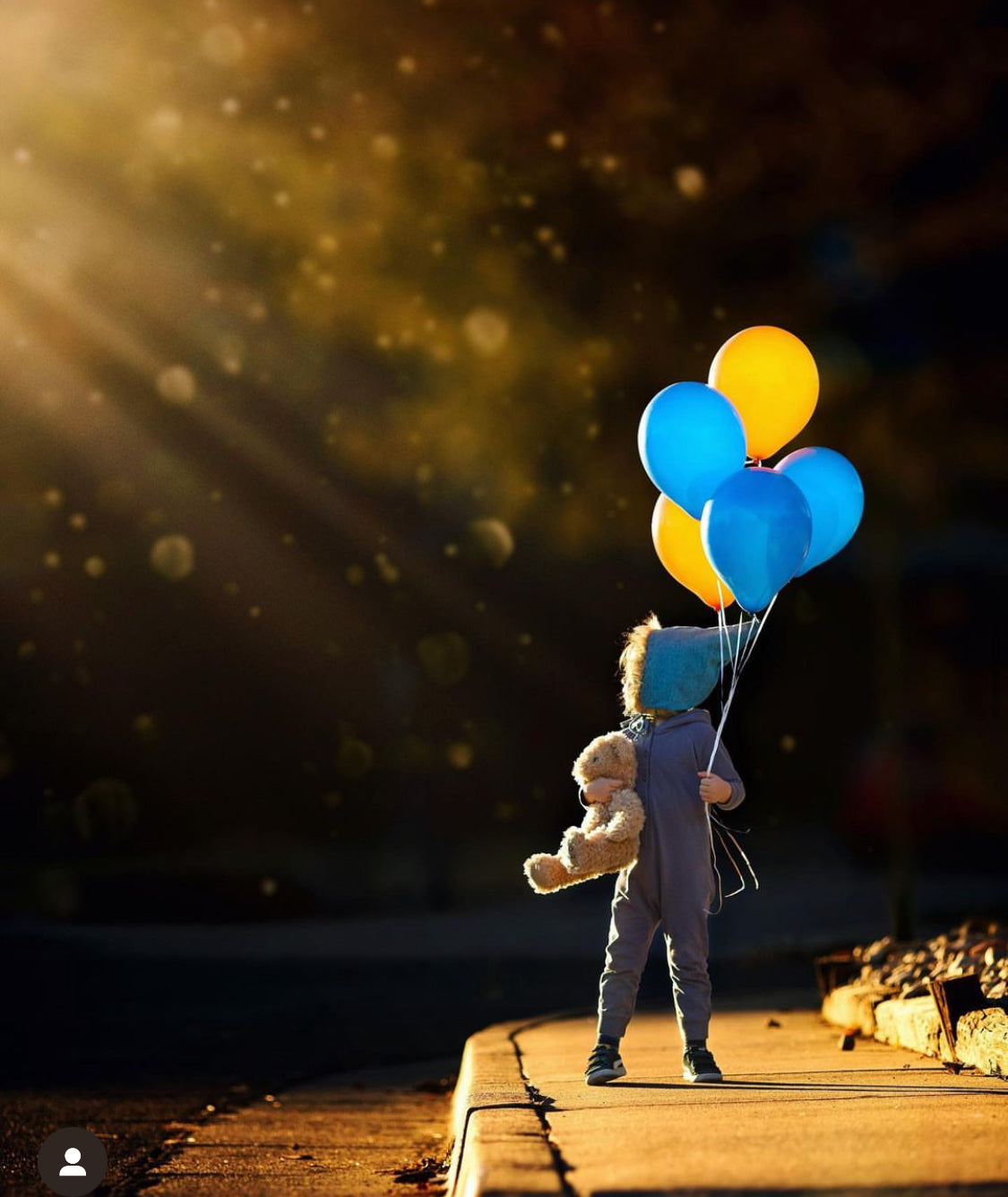 Child holding balloons, FullSizeRender