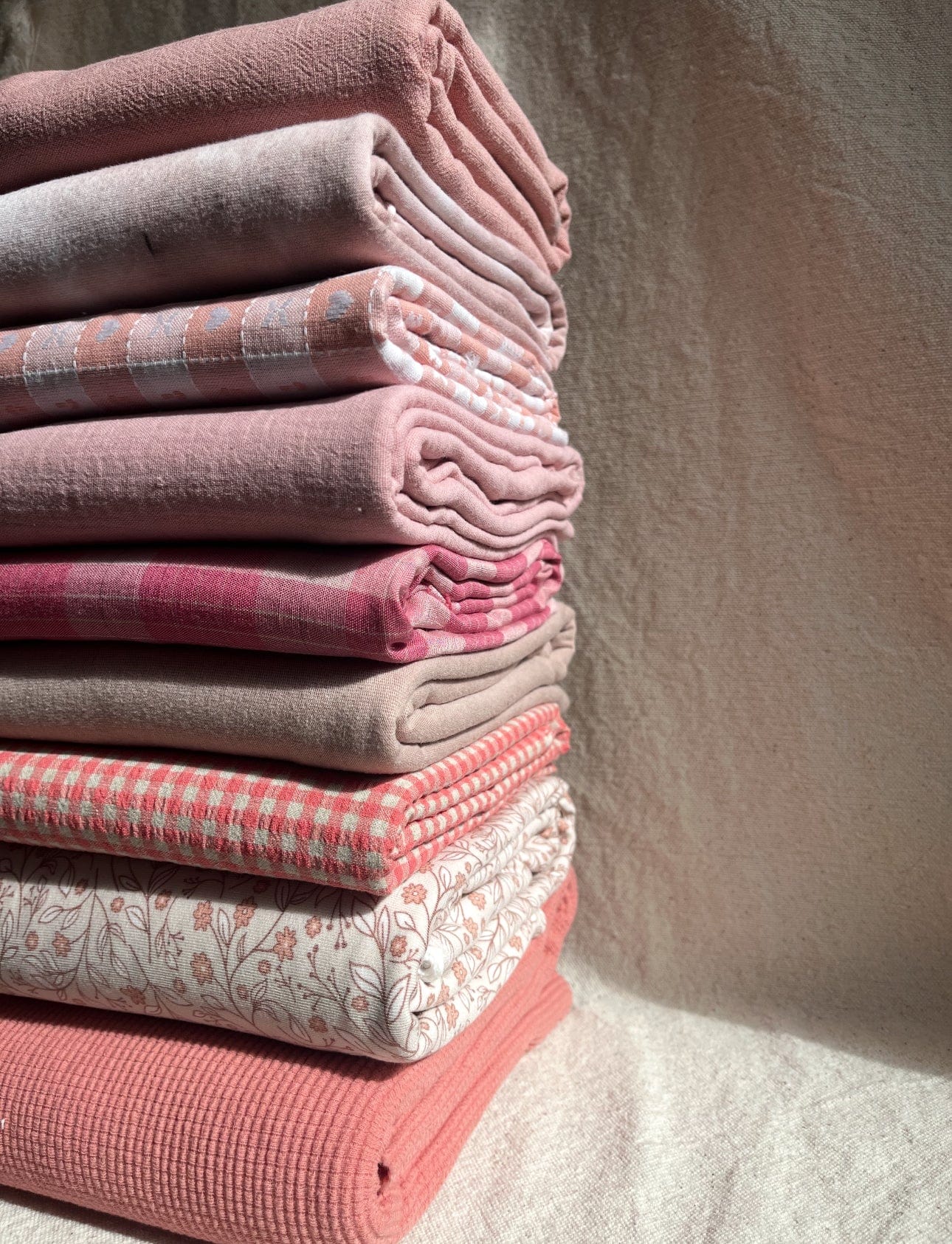 Stack of pink and patterned textiles