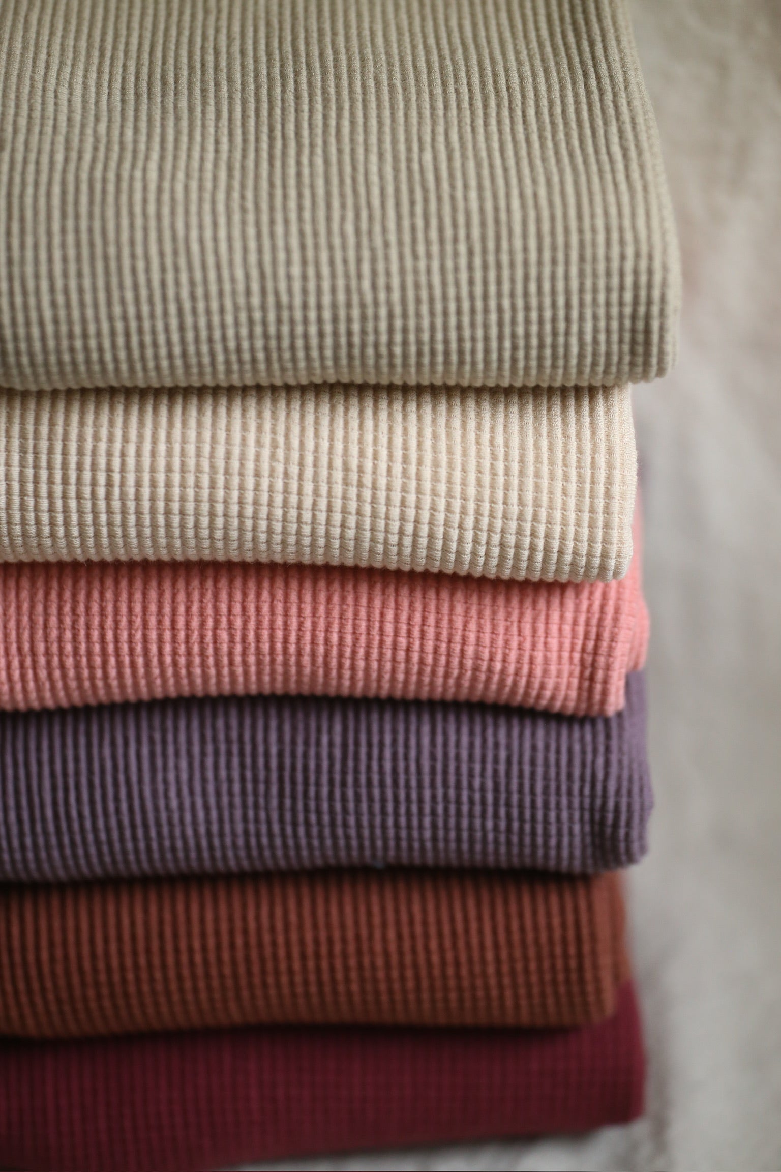 Stack of colorful ribbed fabric.