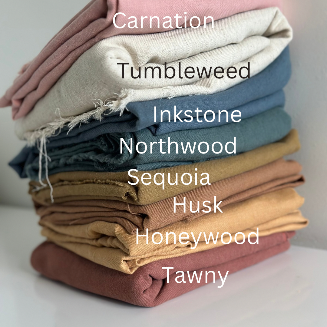 Pile of folded fabric in various colors.