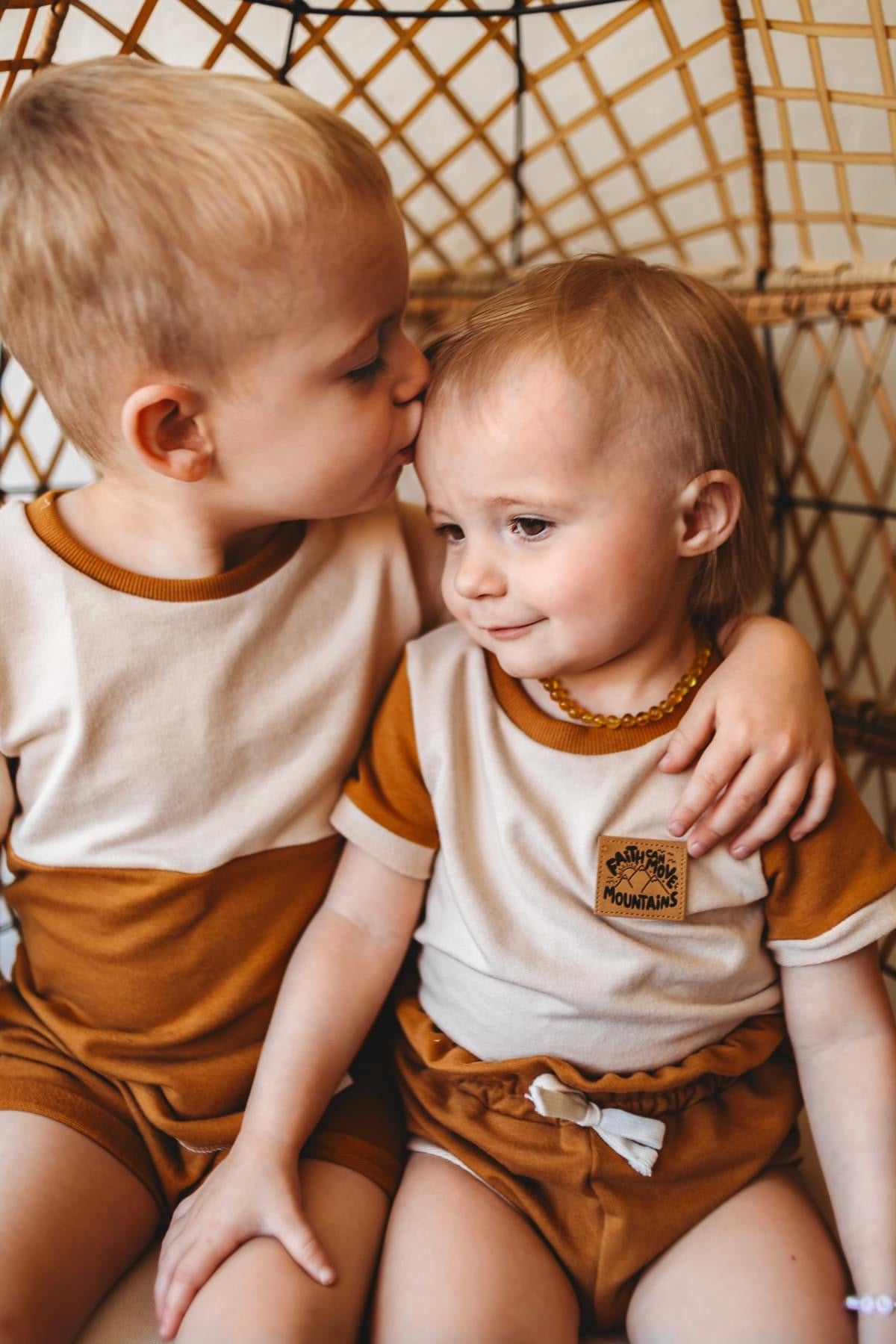 Two young children in matching outfits.