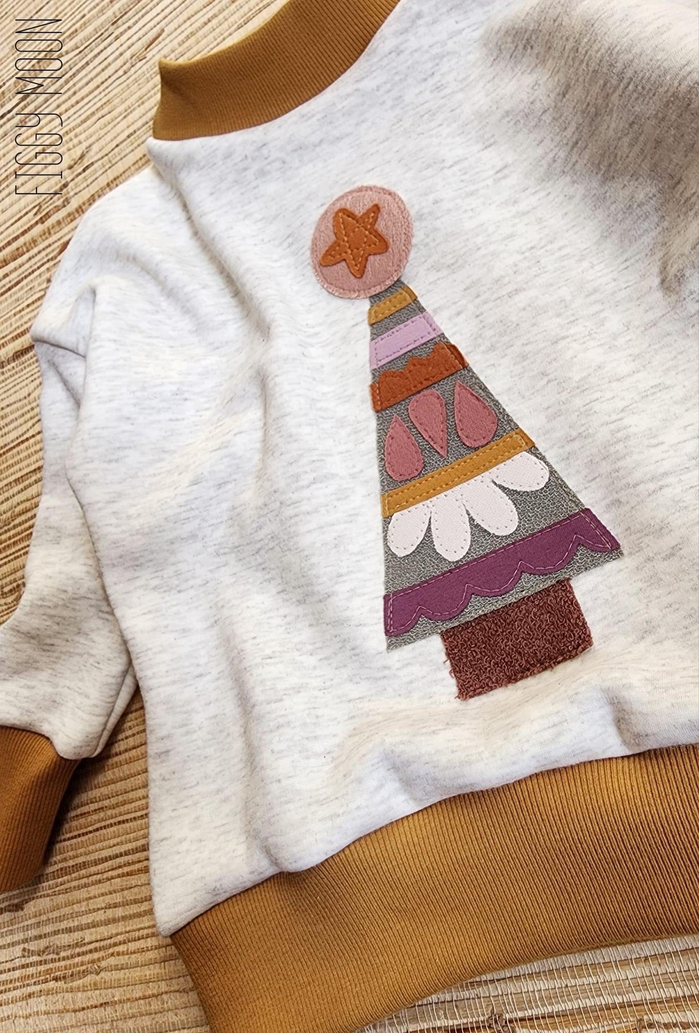 Sweatshirt with Christmas tree applique.