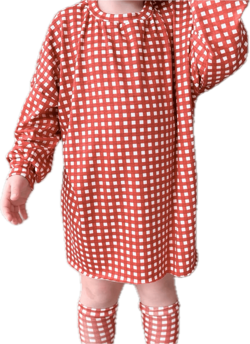 Child wearing red and white checkered dress and socks.