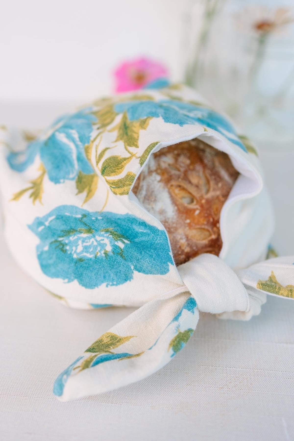 Loaf of bread in blue floral fabric wrap.