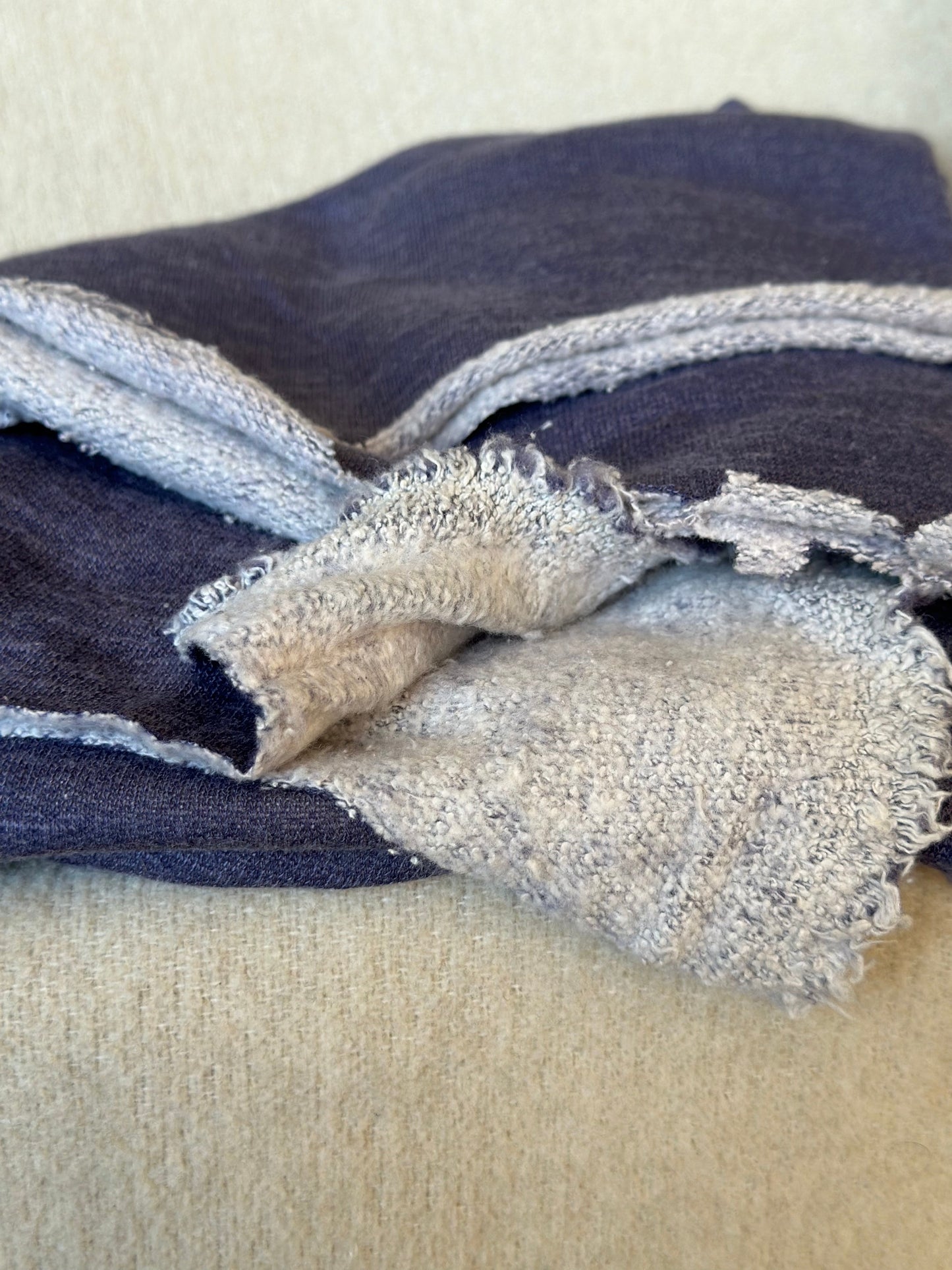 Folded blue fabric with frayed edges.