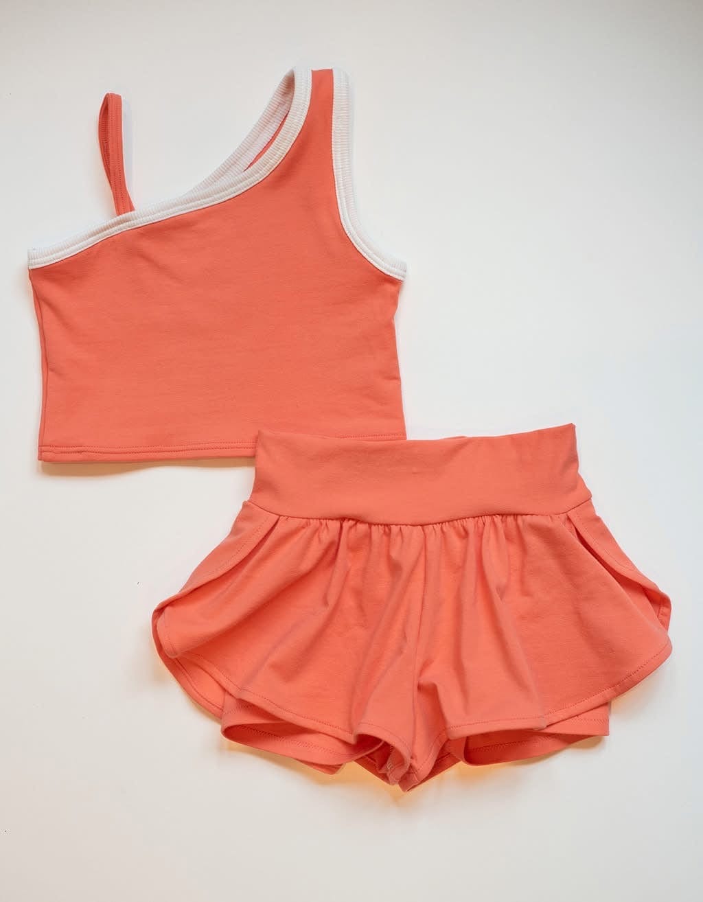Coral-colored crop top and shorts set.