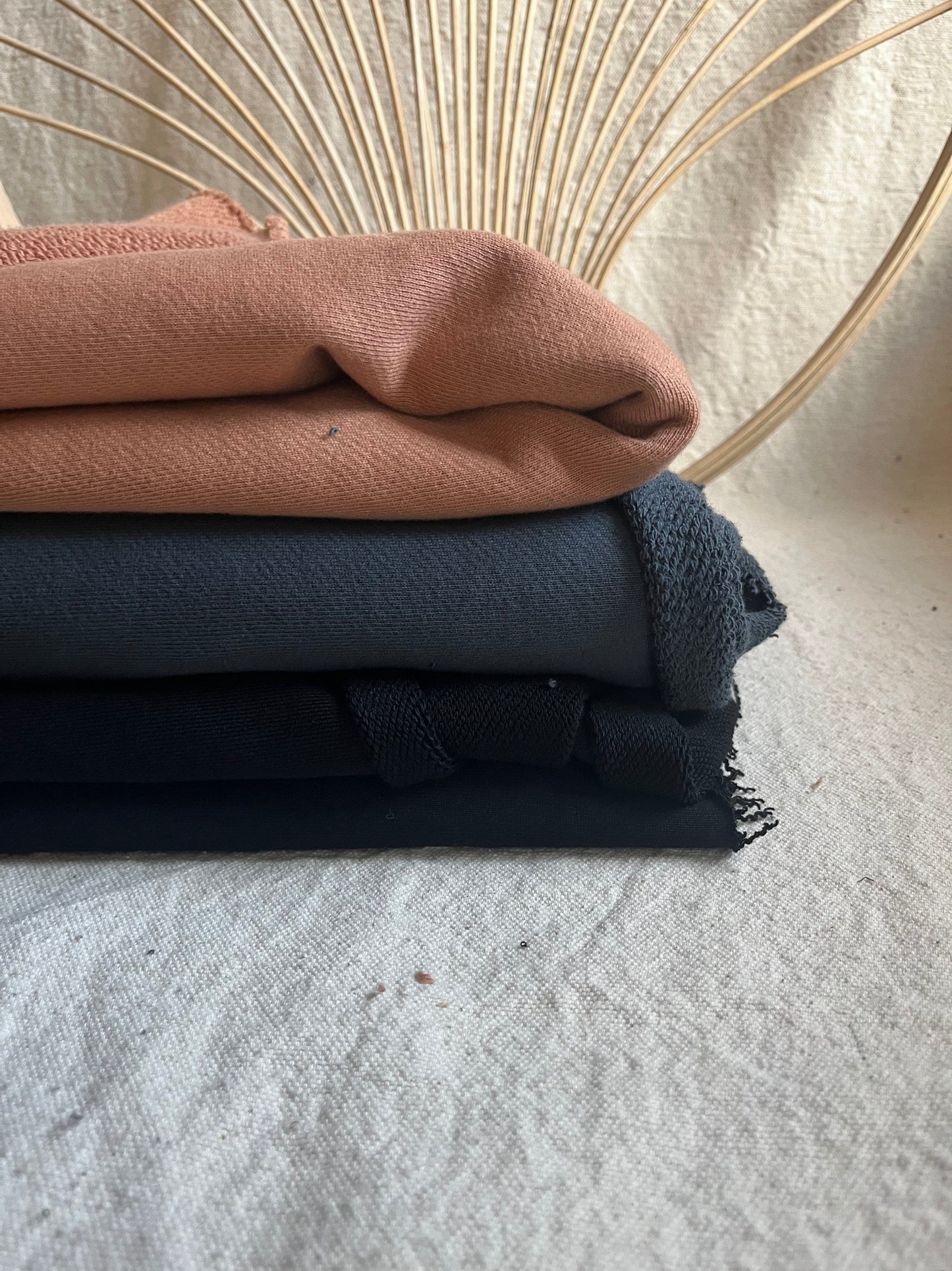 Stack of three folded fabric items.
