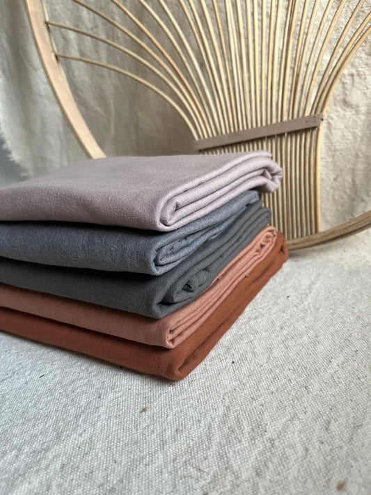 Stack of folded fabric in various colors.