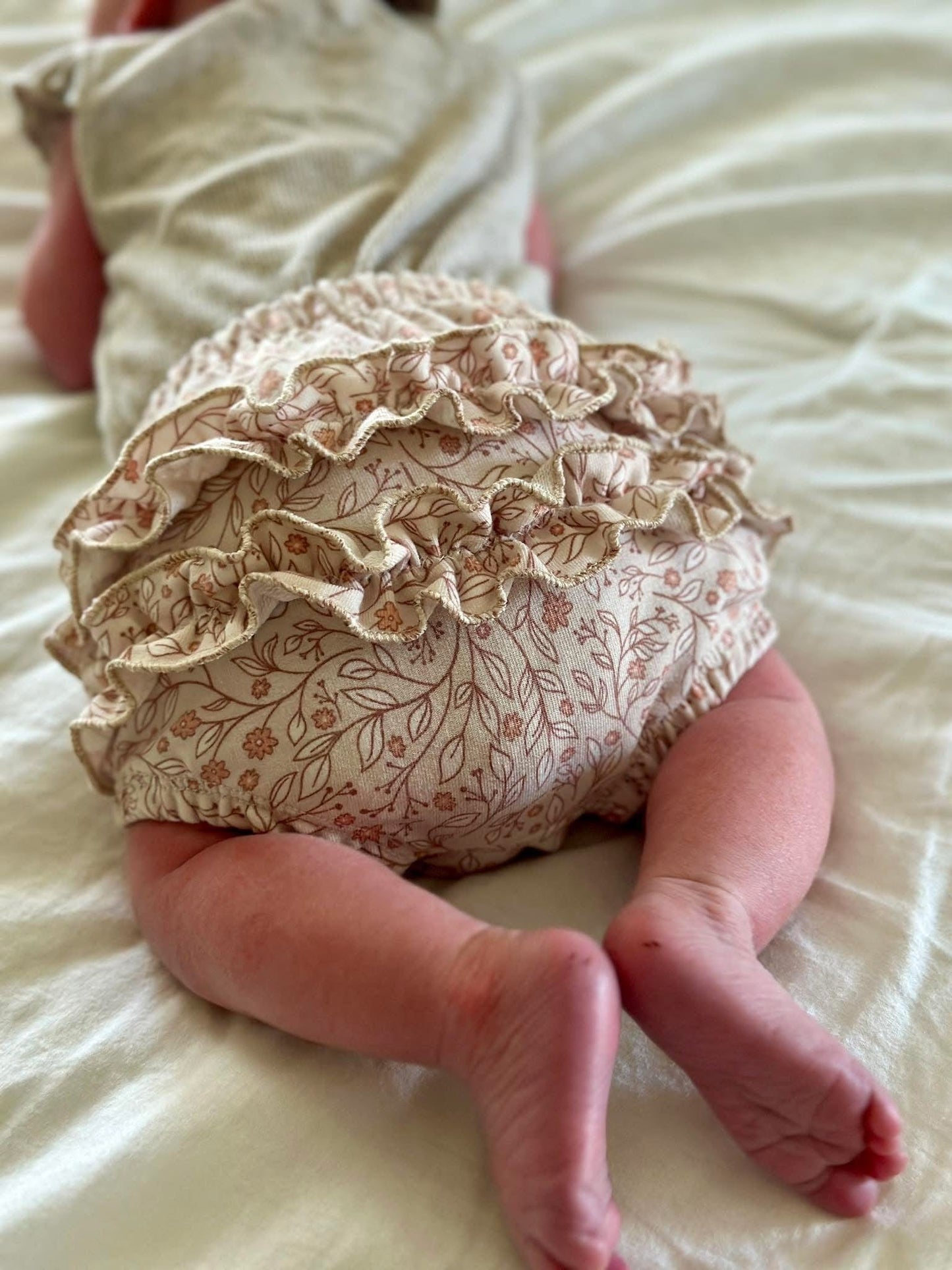 Baby wearing floral diaper cover