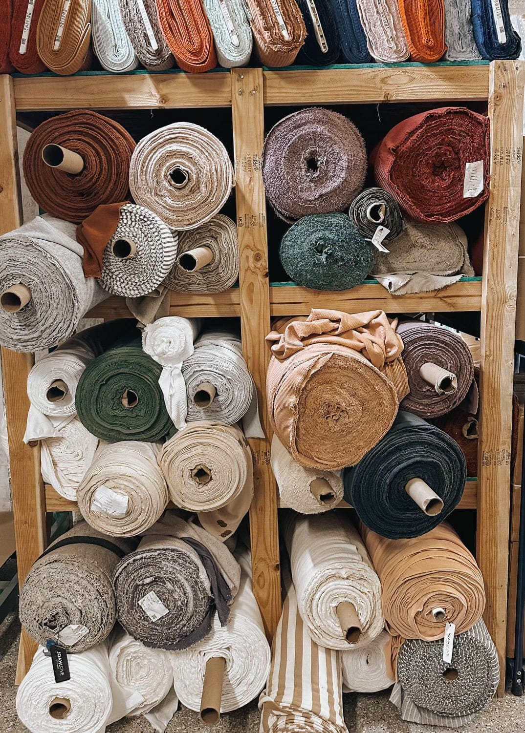 Shelves stacked with rolls of fabric.