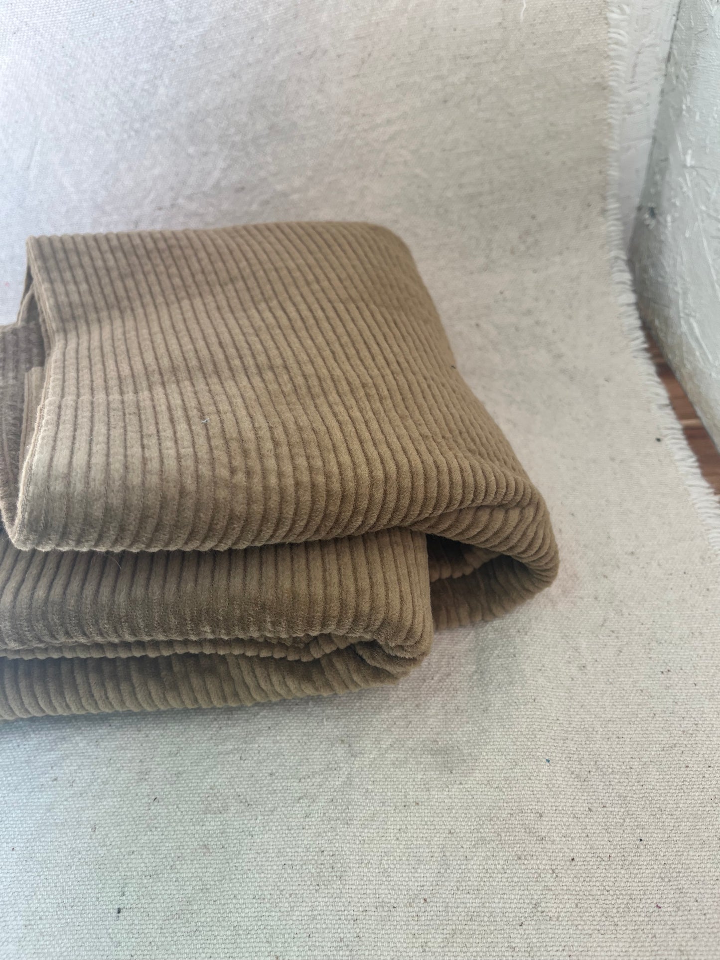 Folded brown corduroy fabric.