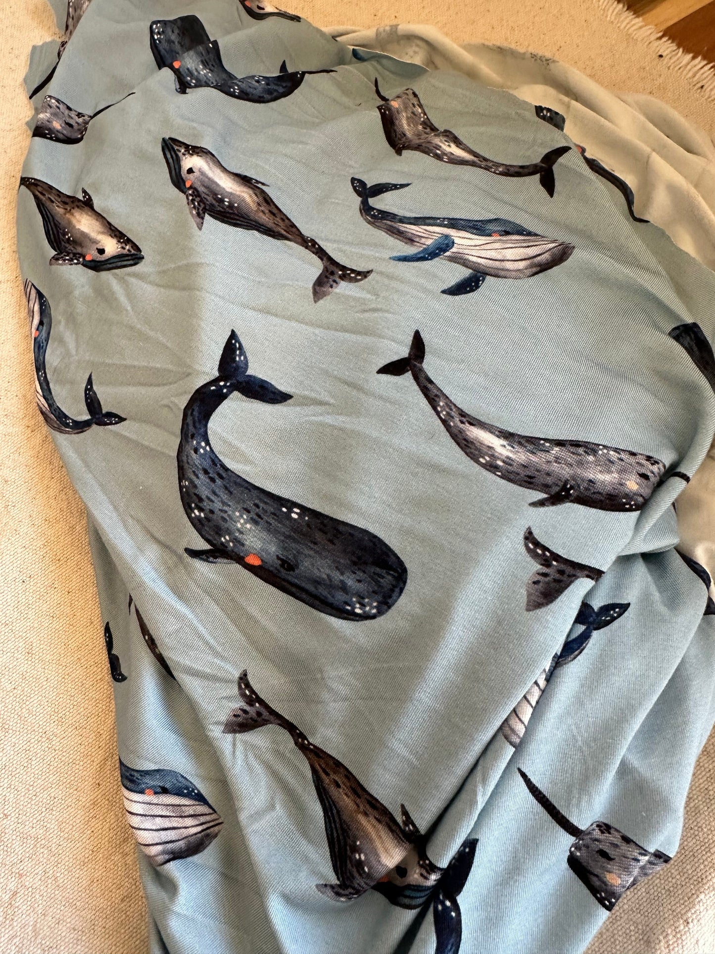 Blue fabric with whale pattern.