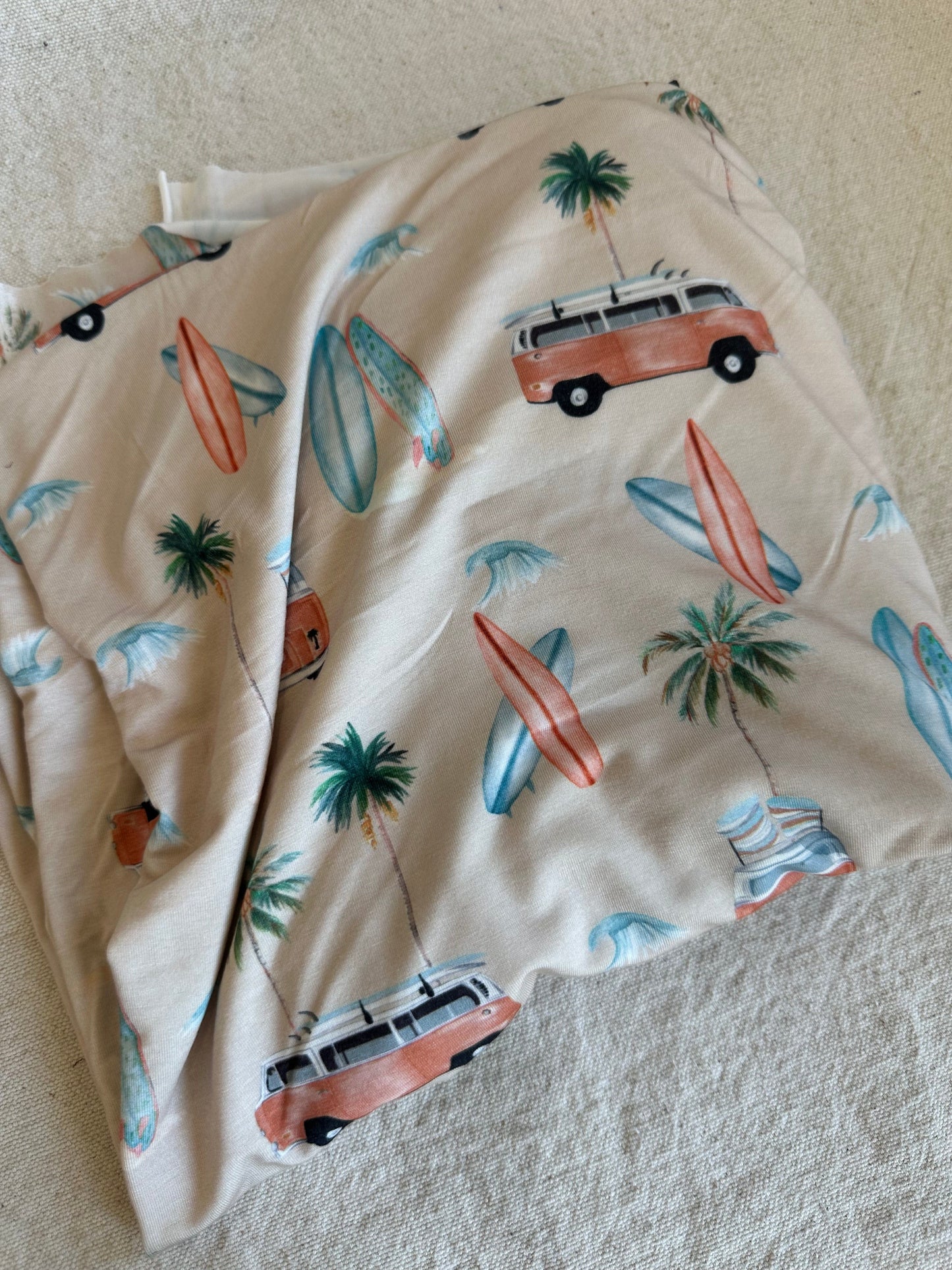 Fabric with surfboards, palm trees, and vans.