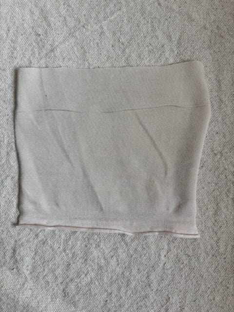 Gray tube top on textured surface.