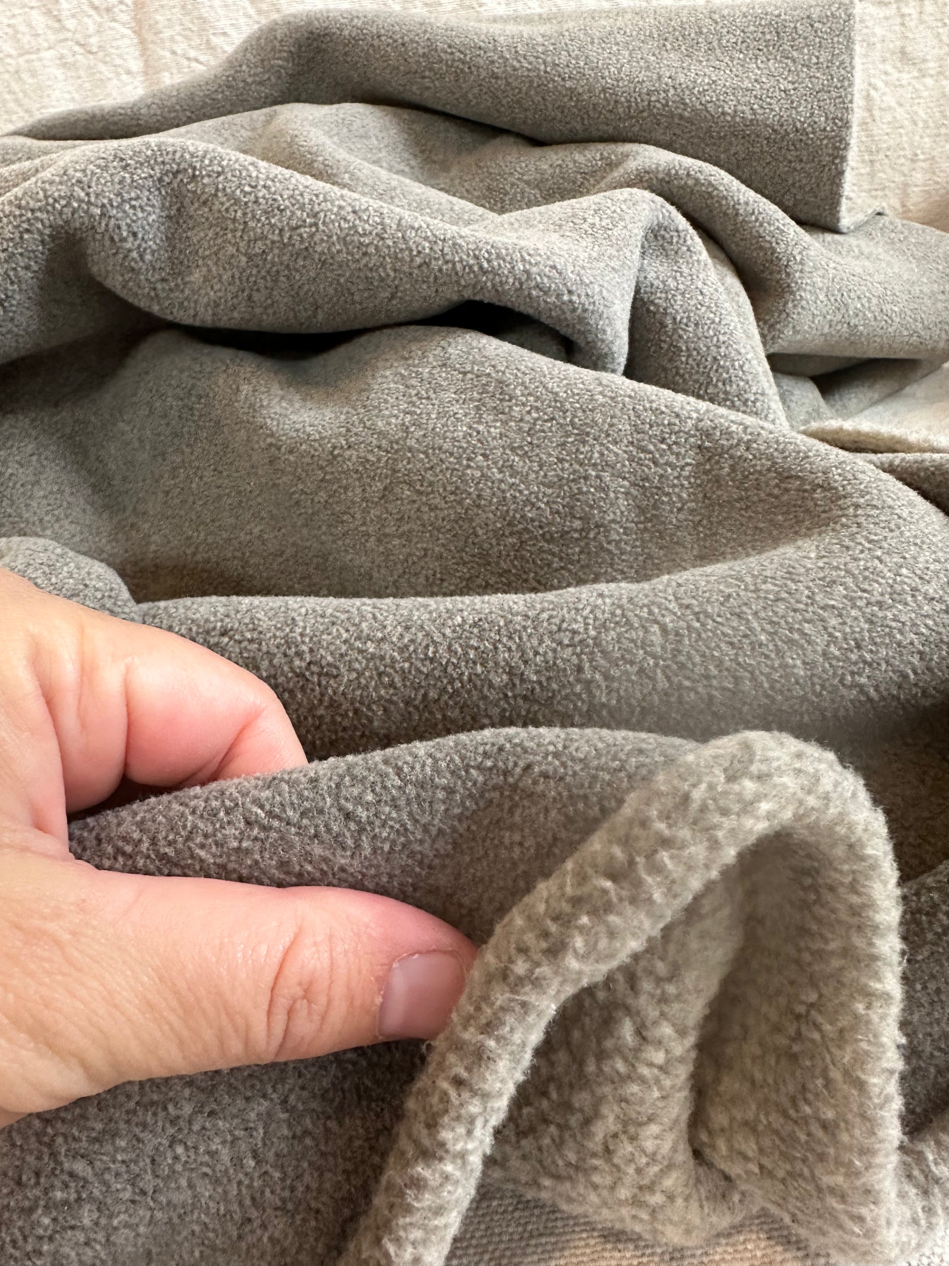Polar fleece fabric in teddy bear texture, draped to display plush thickness and luxurious softness. 21 oz heavyweight fleece fabric designed for warm clothing, outerwear, and cozy home décor. Wide 58–60 inch fleece fabric, machine washable and easy to care for