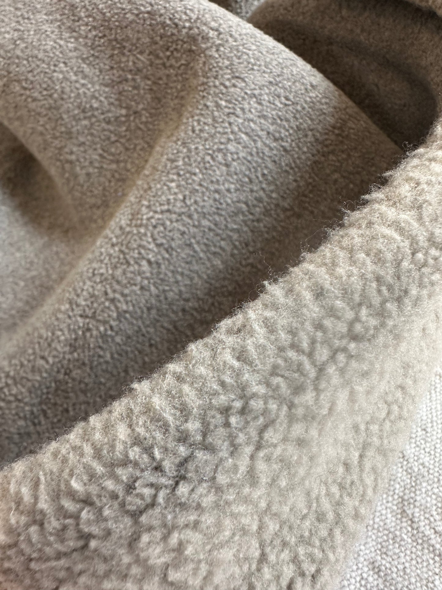 Close-up detail of plush teddy bear polar fleece fabric in 21 oz heavyweight thickness. Thick, fluffy fibers highlight the soft and cozy texture, perfect for jackets, loungewear, and pet beds. High-quality polyester fleece fabric that provides warmth, durability, and comfort for winter sewing projects.