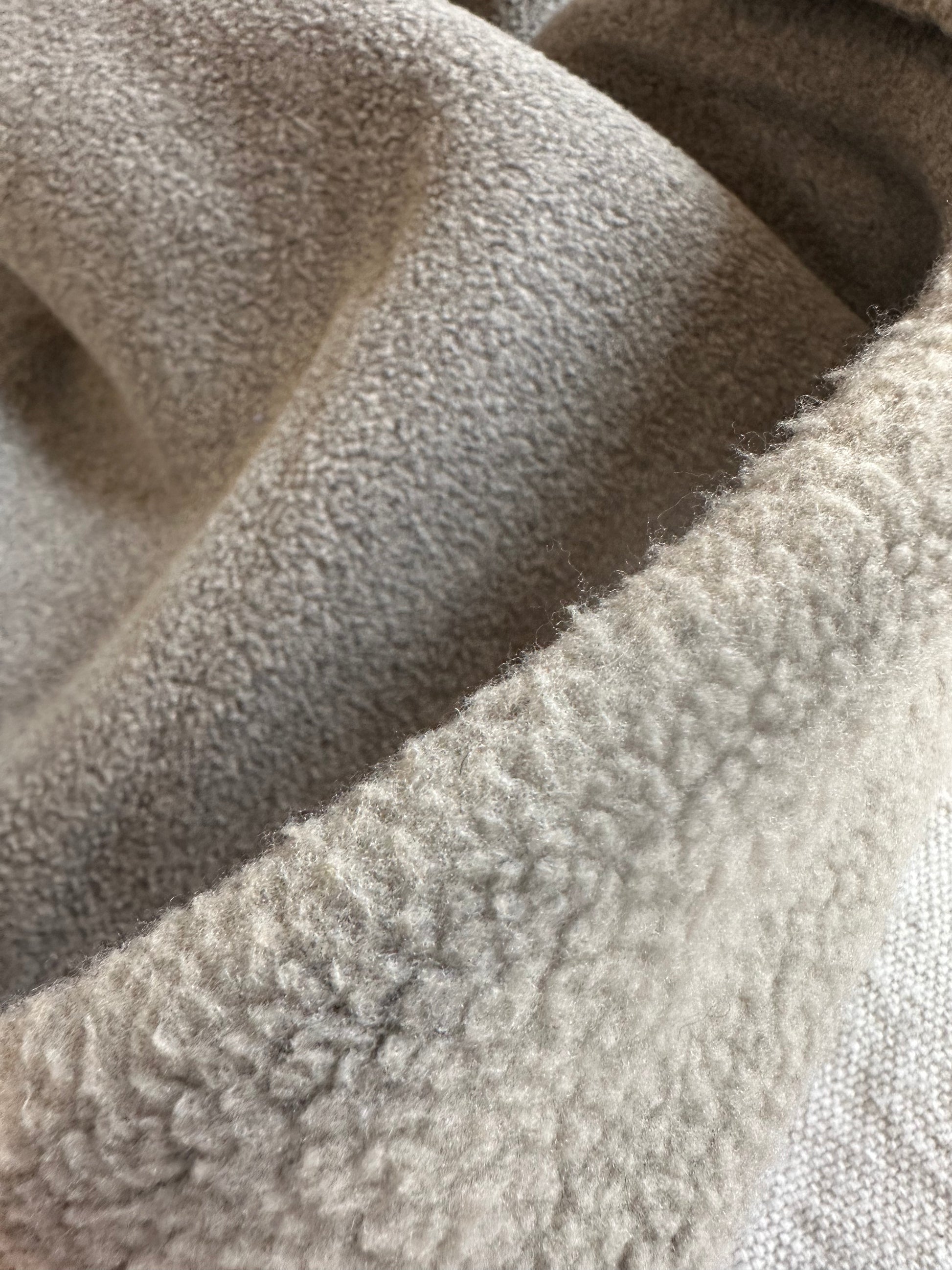 Close-up detail of plush teddy bear polar fleece fabric in 21 oz heavyweight thickness. Thick, fluffy fibers highlight the soft and cozy texture, perfect for jackets, loungewear, and pet beds. High-quality polyester fleece fabric that provides warmth, durability, and comfort for winter sewing projects.