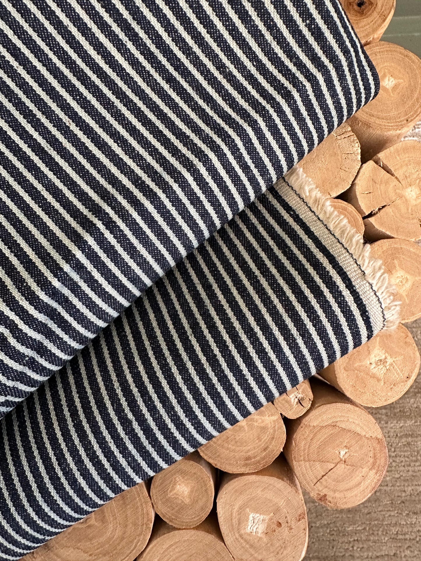 Vintage 90’s salvaged pinstripe denim fabric in a mid-blue wash, shown in a 12 oz weight and 60-inch width. The fabric features subtle woven pinstripes and a sturdy workwear texture with a true vintage look. Ideal for sewing jeans, jackets, bags, aprons, kidswear, and durable handmade garments. Sustainable reclaimed denim rescued from past production. Perfect for timeless sewing projects