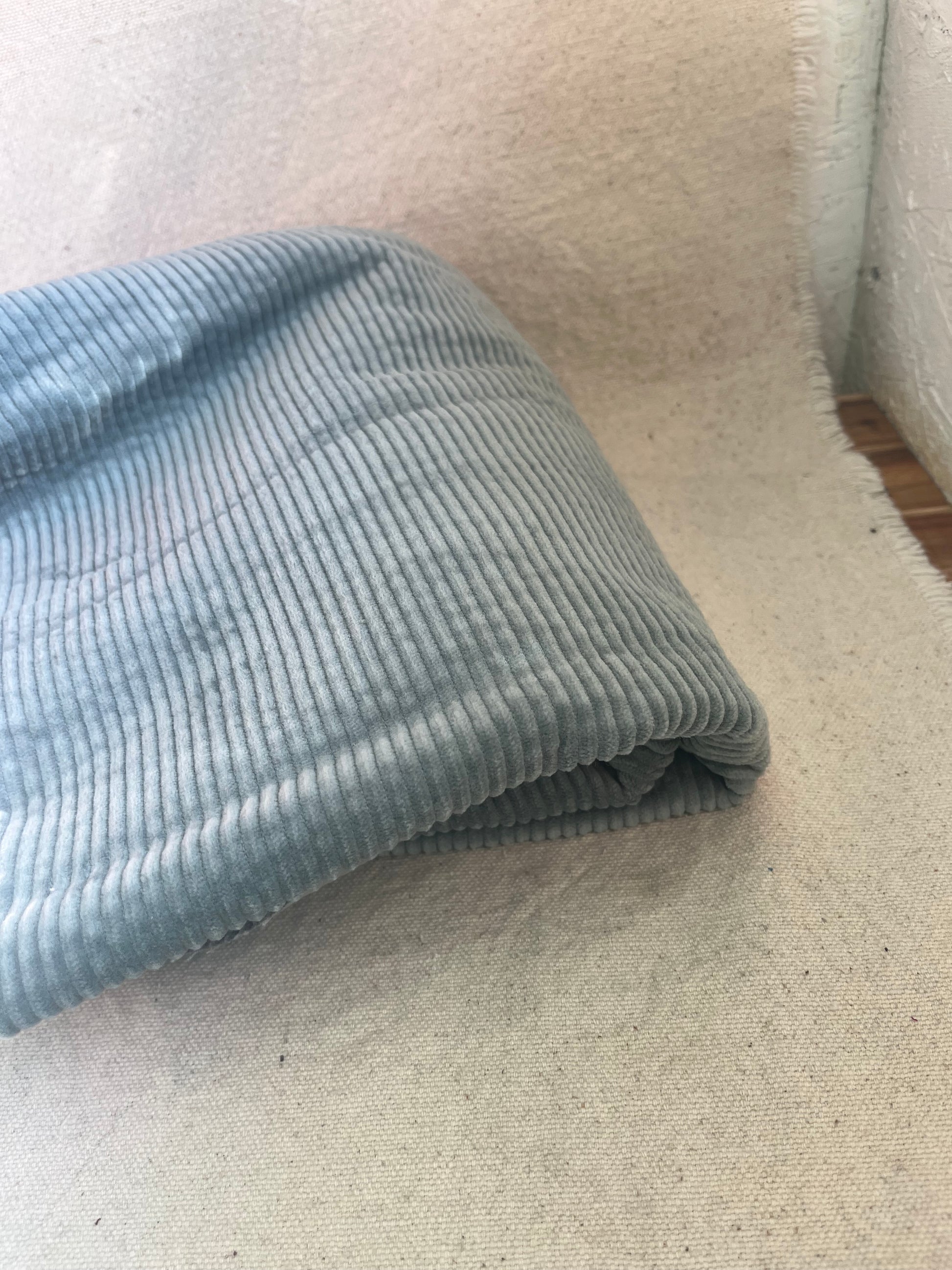 Folded blue corduroy fabric.